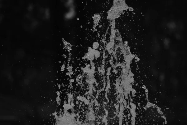 abstract background of water shooting up in the air monochrome texture. image including effect the black and white tones.