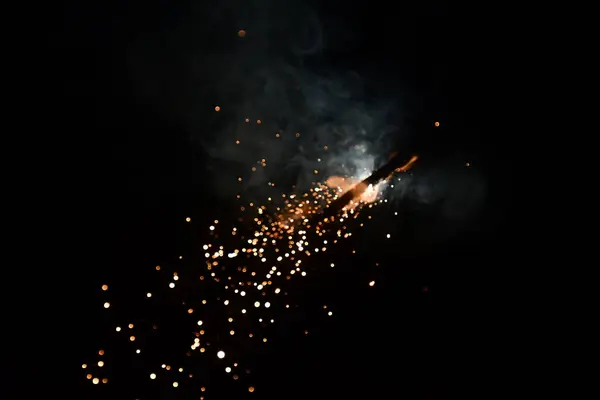 sparks of the fire on a black background resembling a galaxy