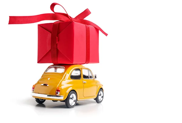 Carro Brinquedo Amarelo Entrega Caixa Presente Vermelho Com Fita Fundo — Fotografia de Stock