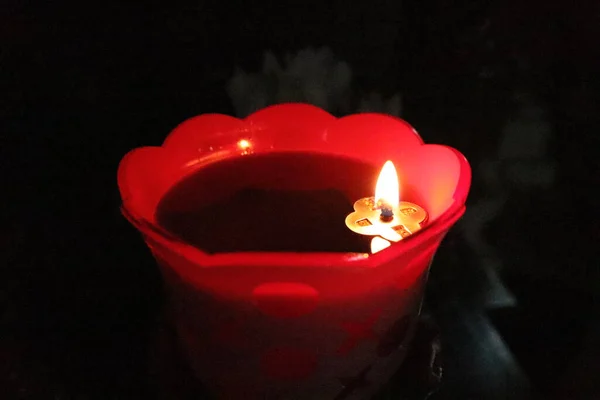 candle in the form of a heart on a black background