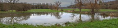 Normandy, France, Europe : Exterior photo view water floods due to climate change in fields creating damage disaster in agriculture environement clipart