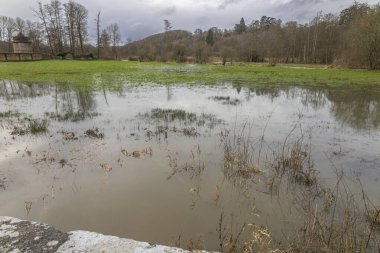 Normandy, France, Europe : Exterior photo view water floods due to climate change in fields creating damage disaster in agriculture environement clipart