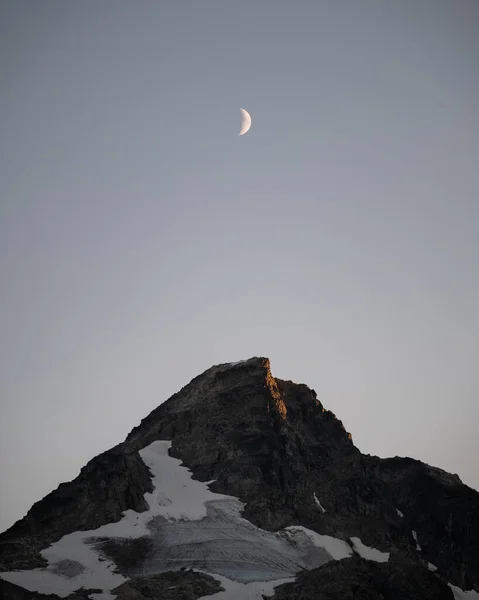 Moon over mountain peak