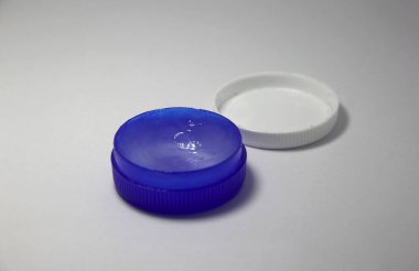 Small opened ointment blue container on simple white background. Can be used for beauty or medical purpose.