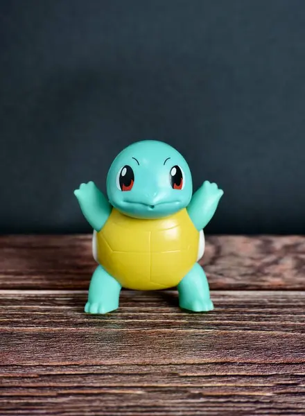 stock image Jakarta, Indonesia - July 3rd, 2024 - Pokemon animal turtle squirtle character Mcdonalds happy meals bonus. Children or kids toys figure object isolated on vertical dark wooden surface background.