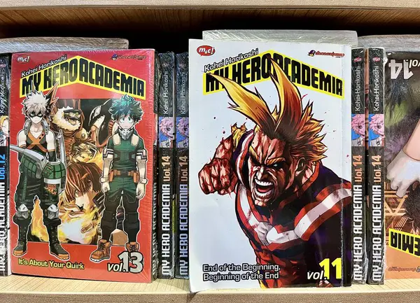 stock image Jakarta, Indonesia - July 18th, 2024 - Boku no hero academia volume 11 with all might on the cover. Comic book cover in Gramedia book store wooden shelf isolated on horizontal ratio background.