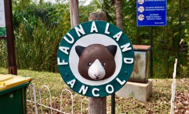 Jakarta, Indonesia - August 6th, 2024 - Faunaland Zoo Ancol logo and round wooden sign banner isolated on horizontal outdoor environment background. clipart