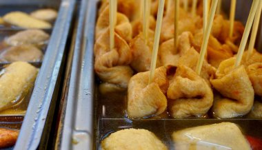 Sokak yemekleri, balık köfteleri ve şiş aperatifleri yatay restoran konteynırında izole edilmiş sıcak çorba içinde..