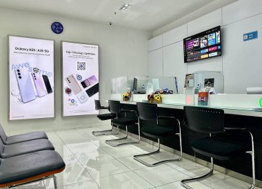 Jakarta, Indonesia - August 26th, 2024 - Samsung service center interior counters and waiting zone isolated on horizontal indoor white wall and flooring background. clipart