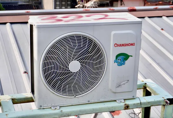 stock image Jakarta, Indonesia - August 24th, 2024 - Changhong air conditioner fan compressor object isolated on horizontal outdoor rooftop environment background.