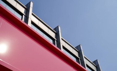 Wide and tall pink and gray shophouse building exterior with windows structure isolated on horizontal ratio outdoor blue sky background. clipart