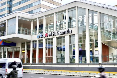 Jakarta, Indonesia - November 19th, 2024 - Transjakarta bus stop MH Thamrin in front of Sarinah building isolated on horizontal ratio outdoor city street background. clipart