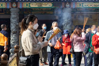 2023 Jan 5,Hong Kong.At Wong Tai Sin Temple, citizens knelt on the ground and drew lucky sticks.