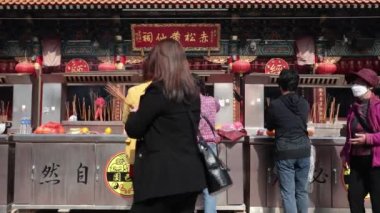 2023 Jan 5,Hong Kong.At Wong Tai Sin Temple, citizens knelt on the ground and drew lucky sticks.