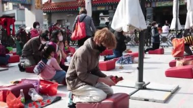 2023 Jan 5,Hong Kong.At Wong Tai Sin Temple, citizens knelt on the ground and drew lucky sticks.