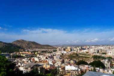 October 2022 - Cartagena, Spain- Spanish city of Cartagena on the shores of the turquoise Mediterranean sea from a bird's eye view on a sunny day