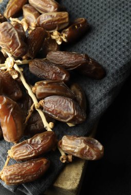 Dry dates fruit isolated on dark background. View from above. 
