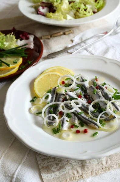 Marinated sardine fillets in white plate. White sardine fillets. Healthy seafood. Vegetarian food.