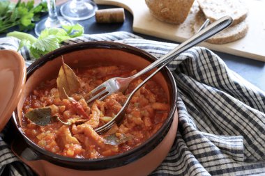 Italian food. Beef tripe with tomato sauce on rustic table. Directly above.