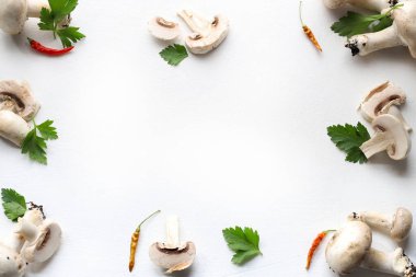 Frame of fresh mushroom, parsley, spice on white background. Champignons mushroom. Healthy food concept. Directly above. Copy space.