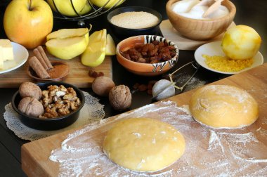 Flat lay composition with ingredients for apple strudel on wooden background. Viennese pastry. Directly above.
