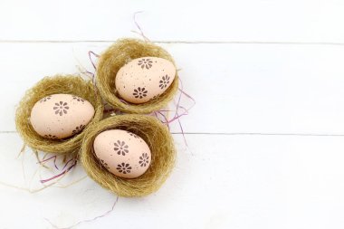 Concept of Easter holiday. Easter eggs in baskets isolated on white background. Copy space. Directly above.