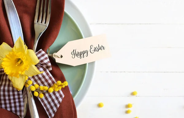 Concept of Easter holiday. Easter table with cutlery on white background. Directly above.