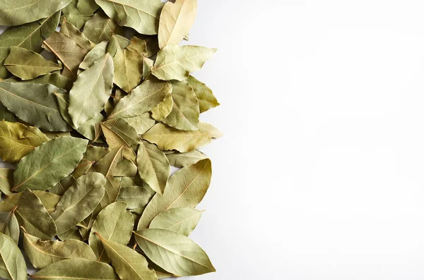 Dried bay leaves pile isolated on white background. Bay laurel leaves. Copy space. Directly above.
