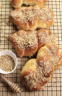 Romanian cuisine. Homemade Mucenici, traditional desserts made in the figure 8 to look like garlands, smeared with honey and  chopped nuts.
