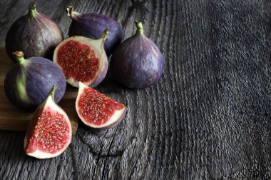 Ripe fresh figs isolated on wooden background. Organic fruit. Healthy mediterranean fruit. Close-up. 