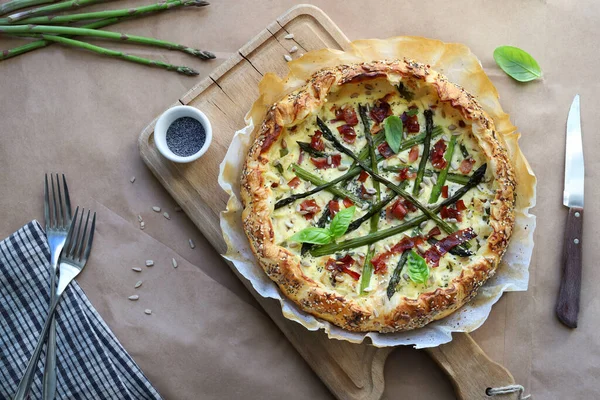 Spring food. Homemade savory pie with asparagus, ricotta and speck. Directly above.