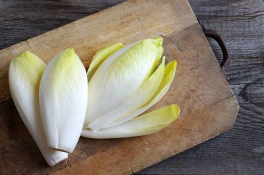 Group of raw endives on a wooden background. Directly above. Copy space. clipart