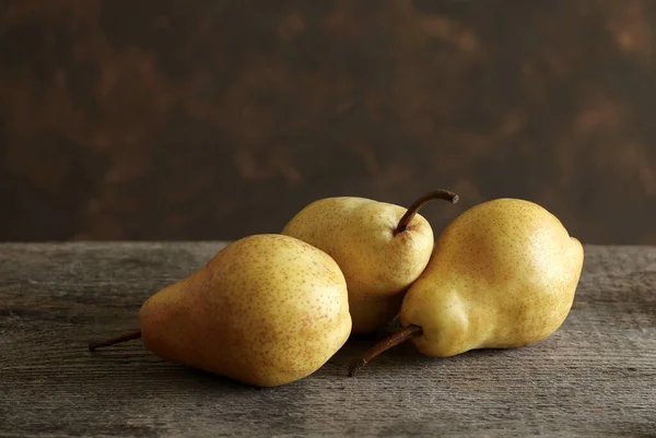 stock image Group of pears isolated on a rustic wooden table. Fresh and Tasty seasonal fruit. Close-up. Copy space.