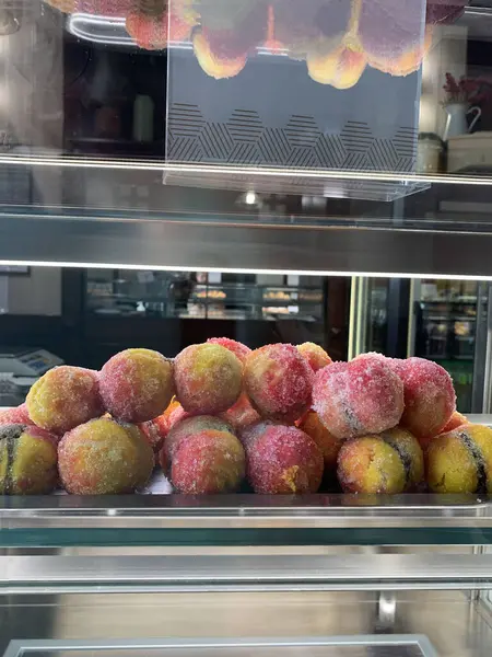 Alchermes peaches. Dessert with cream filling and alchermes in the window of a pastry shop.