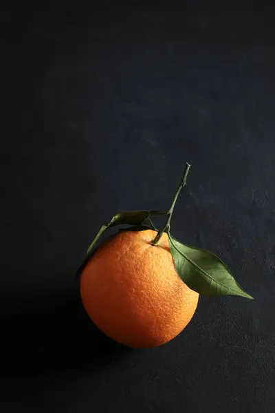 Fresh orange with leaves isolated on black  background. Healthy and vegetarian food. Close-up. Copy space.