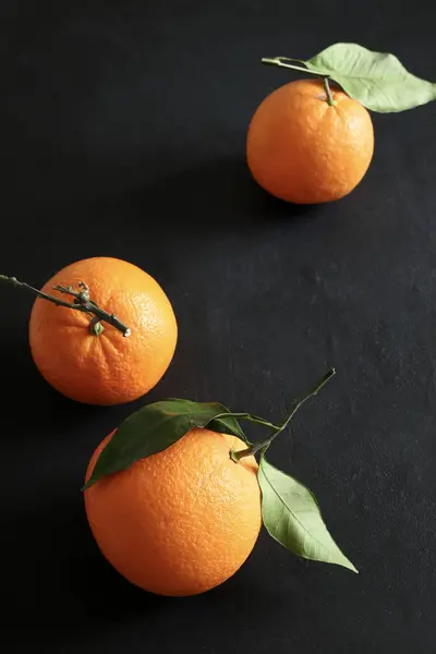 Fresh orange with leaves isolated on black  background. Healthy and vegetarian food. Close-up. Copy space.