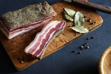 Tahta kesme tahtasının üzerinde gerilmiş domuz göbeği, gri arka plan. Genel bakış. Boşluğu kopyala.