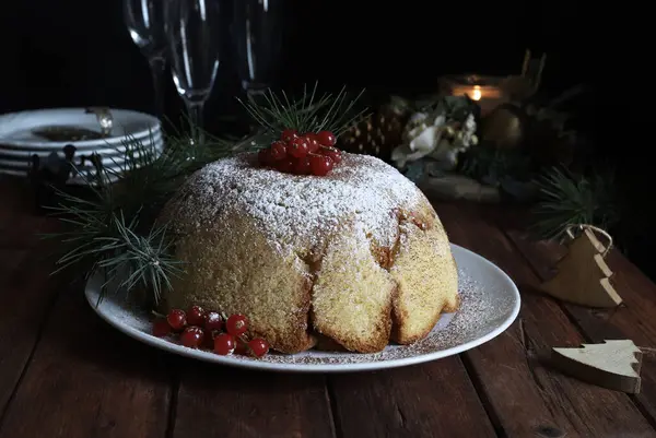 Italian Christmas sweet. Delicious Zuccotto pandoro with Raffaello cream. Christmas cake decorated with red currants. Christmas and holidays.