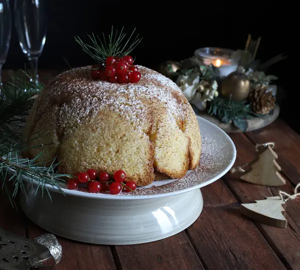 Italian Christmas sweet. Delicious Zuccotto pandoro with Raffaello cream. Christmas cake decorated with red currants. Christmas and holidays.