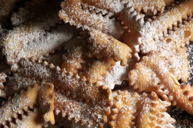 Ev yapımı geleneksel İtalyan karnaval tatlıları: koyu arkaplanda chiacchiere. Uzayı kopyala Tam üstte.