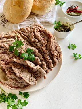 Italian food. Cooked lampredotto ready to prepare the classic Florentine sandwich seasoned with spicy sauce or green sauce. Traditional street food in Florence. Directly above. clipart