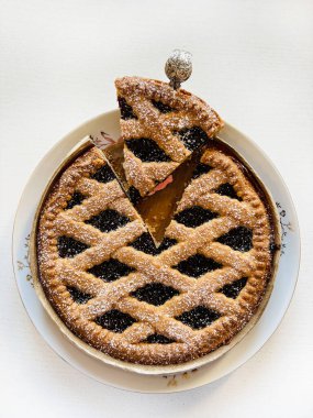 Homemade tart with berries jam on white background. Linzer tart, Austrian dessert. Directly above. clipart