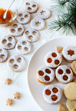 Spitzbuben, homemade Tyrolean biscuits typical of the Christmas period with shortcrust pastry and jam, covered with icing sugar. Holiday season. Directly above. clipart