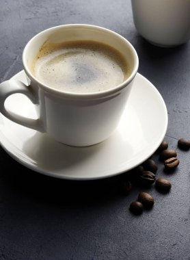 Gri arka planda izole edilmiş bir fincan kahve ve fasulye. Genel bakış. Boşluğu kopyala.