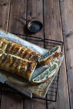 Kırsal ahşap arka planda ricotta peynirli ve ıspanaklı ev yapımı lezzetli turta. Vejetaryen yemeği..