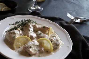 Siyah arka planda beyaz tabakta ev yapımı kremalı tavuk. Genel Görünüm.