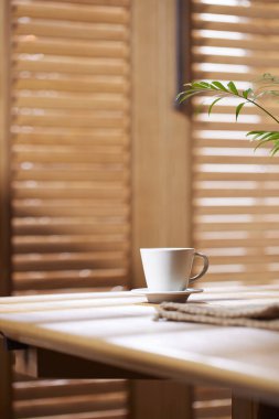 Sıcak ahşap bir iç mekanda güneş ışığı ve gölgeler..