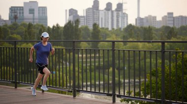 Güneşli bir günde açık havada koşma rutini. Hareketli Motivasyon. Fitness Yolculuğunuza Başlayın.