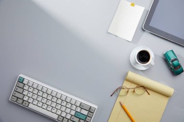 Ofis masası üstü. Bilgisayarlı boş not defteri, akıllı telefon ve masaüstünde bir fincan kahve..
