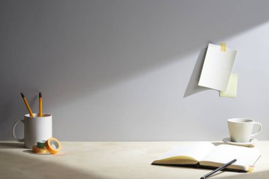 Duvarın yanındaki masada boş bir not defteri. Metin için boşluk